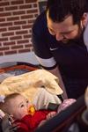 03/65/16 - Rusty Tuders, assistant residence director, talks to Baby Elowyn Curtis during the Residence Life Grill Out event for Sibling Weekend.