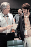 Jim Veneman, assistant professor of communication
arts, analyzes a photo with freshman Kyle Kurlick, journalism major, during the BP Student Journalism Conference. - Photo by Amanda Herron