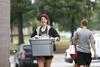 08/232/16 - Emily Johnson, junior biology major, helps a new student move things into the residence complexes during new student move-in day.