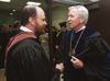 Lee Benson, left, Union's faculty of the year, speaks with Dr. James S. Netherton, president of Carson-Newman College, shortly before Union's August graduation ceremony. - Photo by Jim Veneman