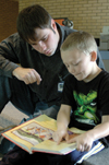 Senior Clint Smith spent time with children at Nova Elementary during Day of Remembrance. - Photo by Lindsay Stavish