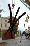 Contemporary artist STRETCH, right, oversees the installation of his sculpture, "Guardian."  This piece is one of the selections for the Jackson Union Sculpture Tour (JUST). - Photo by Amanda Herron
