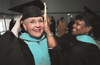 Claudett Metcalf, education specialist student from Cordova, Tenn., assists Dr. Nancy Easley, director of Graduate Studies in Education in Germantown, minutes before graduation begins.
 - Photo by Jim Veneman