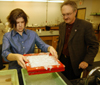 Senior Melanie Rickett takes the tray of paper pulp to the next step of the paper making process, as chemistry professor Jimmy Davis supervises. - Photo by Morris Abernathy