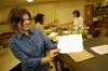 11/16/04 - Senior Melanie Rickett proudly displays the paper she made in an experiment she plans to use in the elementary classroom.