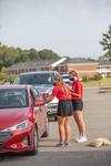 08/227/20 - Student residence advisors check in new students inside their vehicles during Move-in Day.