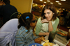 Junior learning foundations major Kerra Kunce spends some special time with a little girl at the Carl Perkins Christmas Special. - Photo by Morris Abernathy