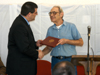 2/25/05 - Charles Fowler (left), senior vice president for university relations, presents Jerry Hughes with his diploma in a recent graduation ceremony at the Turney Center prison. 