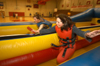 Enrollment Counslers Nikki Castles and Lisa Whiffen try out one of the inflatable games before the incoming freshman come and play during the Spring Thing weekend.  - Photo by Morris Abernathy