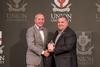 11/307/23 - Clay Hallmark, senior pastor of First Baptist Church in Lexington, Tenn. and TBC president, receives the Alumnus of the Year Award from President Oliver at the Meritorious Service Awards Banquet during Homecoming Week.