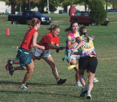 Tie Dyed Michelle Pierce and Lindy Wilson attempt to allude Chi Omega Sophomores Ruth Schroder and Abby Brooks during a Women's Intramural Flag Football game.
