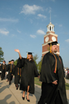 Graduates file onto the Great Lawn for the spring graduation ceremony. - Photo by Jim Veneman