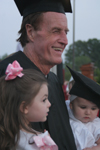 5/21/05 - Bobby Morris celebrates his accomplishment with two of his grandchildren.