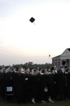 Graduates begin tossing their caps into the air following the conferring of degrees at spring graduation. - Photo by Kathleen Murray
