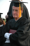 5/21/05 - Bobby Morris tightly holds his physical education and health degree during spring graduation.