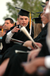 Senior class president Brandon Nelms speaks with those seated next to him during spring graduation. - Photo by Kristen Nicole Sayres