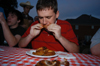 Graduating Seniors Patrick Myers and Wayne Campbell participate in a hotwings eating contest during the Happy Trails social at the Dockery's. - Photo by Morris Abernathy