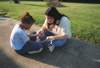 Assignment: Backyard Bible Clubs - Learning Foundations major Meghan Donnely takes time out to pray individually with a young student following their afternoon Bible lesson. - Photo by Kristen Hiller