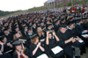 Friends and familes give the Class of 2005 a standing ovation during spring graduation. - Photo by Morris Abernathy
