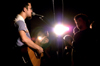 Greenwood, a band formed five years ago by five students at Union University, play their final concert at Union, before relocating to Maryland. Art Wong, lead singer and acoustic guitarist of Greenwood, softly sings to the audience during Greenwood's final concert at Union. - Photo by Jonathan Blair