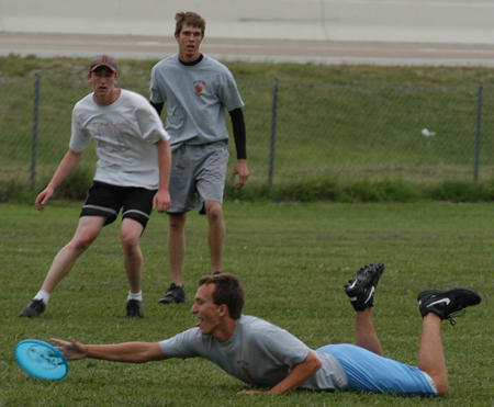 Intramural Ultimate Frisbee Action - SAE Ben Burleson stretches for the disc as Onion David Roach and SAE Kevin Jett look on.