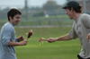 Stephen Goodin and Douglas Martin discover that not only is turkey good to eat but the bones make interesting swords during the Young Alums' Turkey Bowl. - Photo by Kristen Hiller