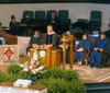 Stanley Warren, music professor, performs <i>Here I Am, Lord</i> during summer graduation. - Photo by Brad Moore