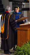 President Dockery presents Carolyn Bishop with a plaque of installation for Senior Fellow in the Institute for International and Intercultural Studies during summer graduation. - Photo by Jim Veneman