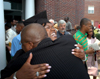 A graduate receives a big hug after summer graduation. - Photo by Morris Abernathy