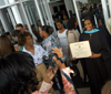 8/6/05 - Master of Education graduate LaKeva Thompson poses with her degree during summer graduation. - Morris Abernathy