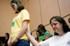 08/27/05 - Debbie Spence of Mount Olive, Ala. holds on to her daughter Elizabeth during the worship service held on the first day of New Student Orientation. - Kyle Kurlick