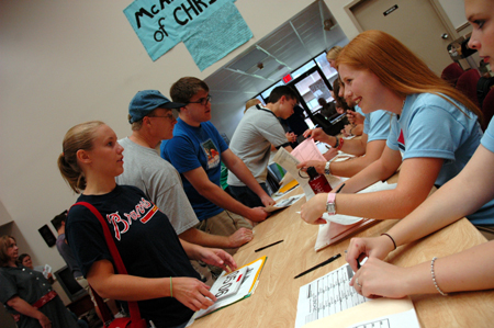 Residence Assistants check new students into the McAfee complex during Freshmen Move-In Day. 