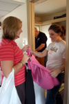 08/27/05 - Kelly Northam of Houston, Tex. takes a look at a skirt with one of her roommates' mothers while her father Bruce finishes a project in her room.