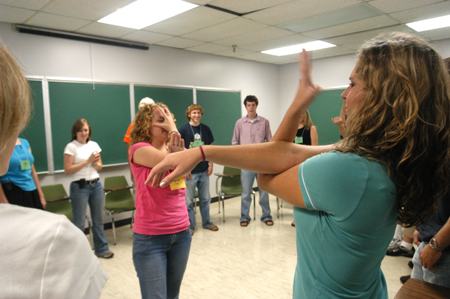 Junior Focus leader Rachel Melton demonstrates a game to Freshman Jenna Cherry of Friendship, Tenn. during New Student Orientation.