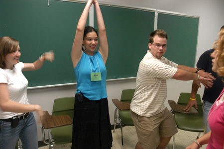 New Students Morgan Channell, Katie Chin, Joshua Armacost demonstrate their technique to their Focus leader Rachel Melton during New Student Orientation.