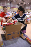 09/5/05 - Juniors Cara Yates & Keely Hart help categorize donated goods at West Jackson Baptist Church to assist Hurricane Katrina victims. - Brad Moore