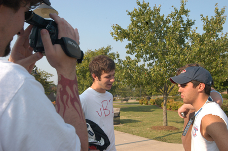 Aaron Hardin stands by to shoot footage for the third episode of <i>uBuzz</i> while Kyle Rains tries to recruit junior Bryan Spillman for the fictitious fraternity <i>Upsilon Beta Zeta.</i>