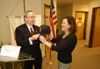 05/18/05 - President Dockery congratulates Dr. Kina Mallard on her new position at Gordon College with a Red Sox cap.