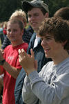 Freshman Matt Elia and others cheer from the sidelines during a Family Weekend flag football game. - Photo by Kyle Kurlick