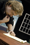 Darren Michael, assistant professor of theatre, goes over his notes before the premiere of <i>Tartuffe</i>. - Photo by Kathleen Murray