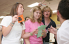 Students Jenna Crotzer, Stephanie Clark and Katrina Parker participate in a Poverty Simulation hosted by the Social Work department. - Photo by Kyle Kurlick