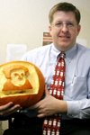 Assistant Professor of Christian Studies Ray Van Neste holds the "Luther-o-lantern" three of his students gave him on Reformation Day. - Photo by Kyle Kurlick