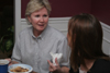 Pam Sutton, professor of English, enjoys some conversation with her students during a dinner in her home. - Photo by Kyle Kurlick