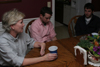 Pam Sutton, professor of English, enjoys some conversation with Senior Justin Belsly and Junior Stephen Goodin after a dinner in her home. - Photo by Kyle Kurlick