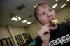 Senior Brad Moore enjoys a caramel apple during SAC's Fallapalooza.  - Photo by Kristen Nicole Sayres