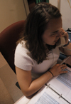 11/7/05 - Sophomore Kristin Jennings answers the phones while working the front desk in the McAfee Commons.