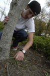 Freshman Ben Trail weeded flower beds on campus during Day of Remembrance. - Photo by Kathleen Murray