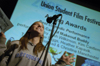 Christina Manchester accepts her award for Best Comedic Performance for her sock puppet in <i>Makeout Buddy</i> during the Third Annual Union Student Film Festival. - Photo by Kathleen Murray