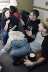 12/2/05 - Sophomore Christina Pool signs with Freshmen Casey Yates and Drew Winter during a open dorms Christmas party.