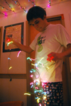 12/5/05 - Senior Chris Hayden untangles a strand of Christmas lights to decorate his dorm room with.